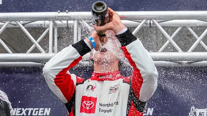 Cameron celebrating on the podium